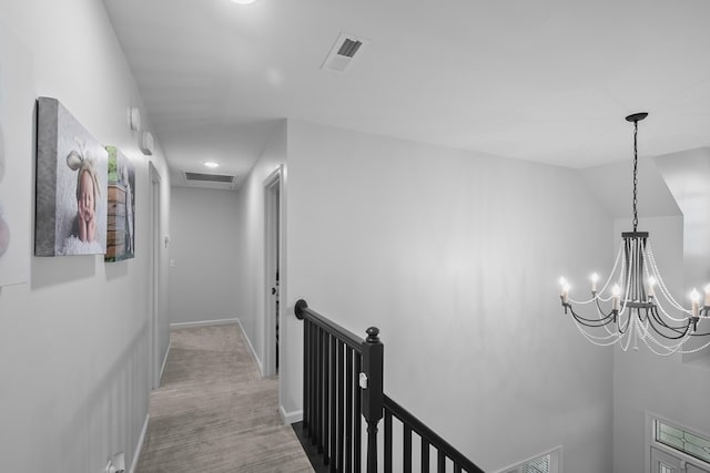 856 S County Rd 49, Dothan, AL 36301 - corridor with an upstairs landing, a chandelier, carpet, and baseboards