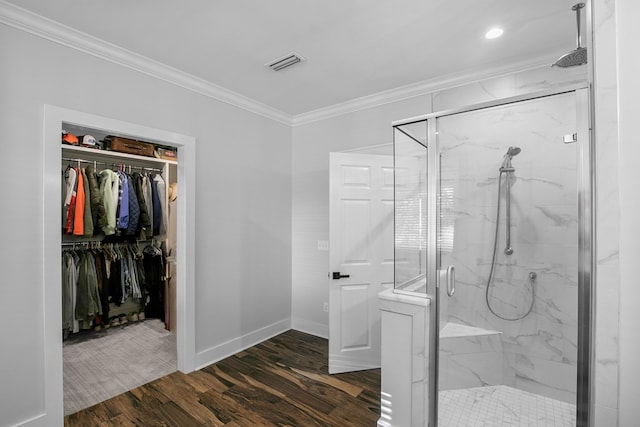 856 S County Rd 49, Dothan, AL 36301 - bathroom featuring ornamental molding, a marble finish shower, wood finished floors, baseboards, and a walk in closet