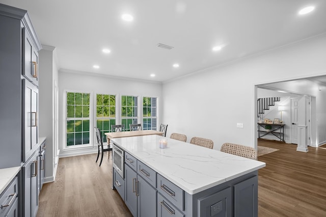 856 S County Rd 49, Dothan, AL 36301 - kitchen featuring a kitchen island, crown molding, dark wood-type flooring, recessed lighting, and light stone countertops