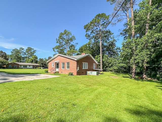 800 W Brookside Ave, Geneva, AL 36340 - view of property exterior featuring brick siding, a lawn, a chimney, and crawl space