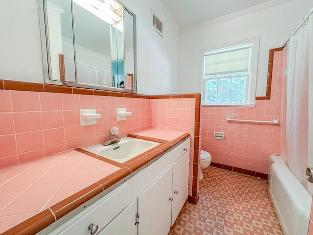 800 W Brookside Ave, Geneva, AL 36340 - full bathroom featuring vanity, tile patterned floors, ornamental molding, tile walls, and shower / bath combination with curtain