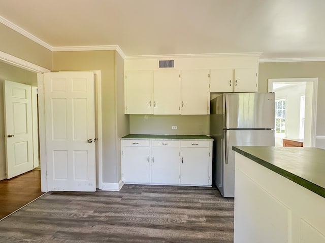 800 W Brookside Ave, Geneva, AL 36340 - kitchen featuring freestanding refrigerator, crown molding, dark wood-style flooring, white cabinetry, and dark countertops