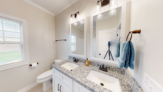 bathroom featuring toilet, vanity, and ornamental molding