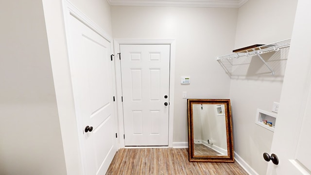 laundry room featuring light hardwood / wood-style floors, crown molding, and hookup for a washing machine