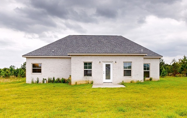 back of house with a patio area and a lawn