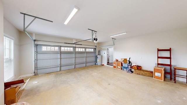 garage with a garage door opener and gas water heater