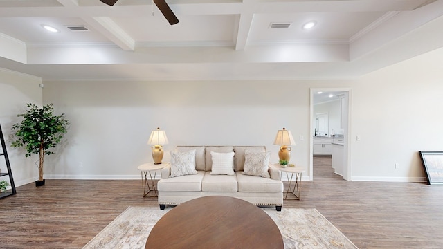 living room featuring crown molding, beamed ceiling, coffered ceiling, and hardwood / wood-style flooring