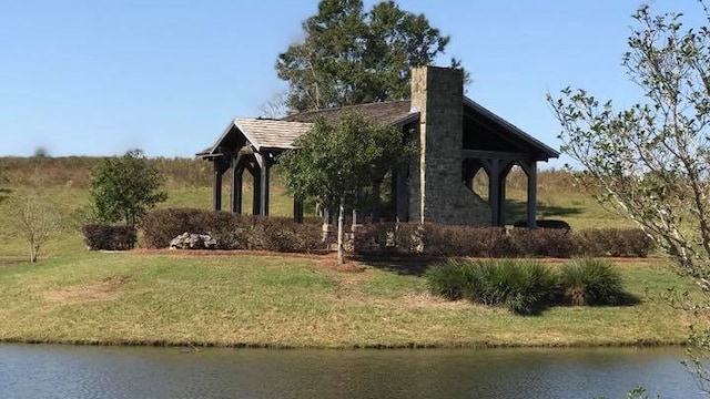 view of home's exterior featuring a yard and a water view