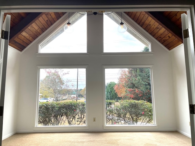 room details with carpet flooring, beam ceiling, and wooden ceiling