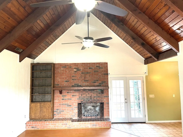 unfurnished living room with beam ceiling, french doors, high vaulted ceiling, a fireplace, and wood ceiling