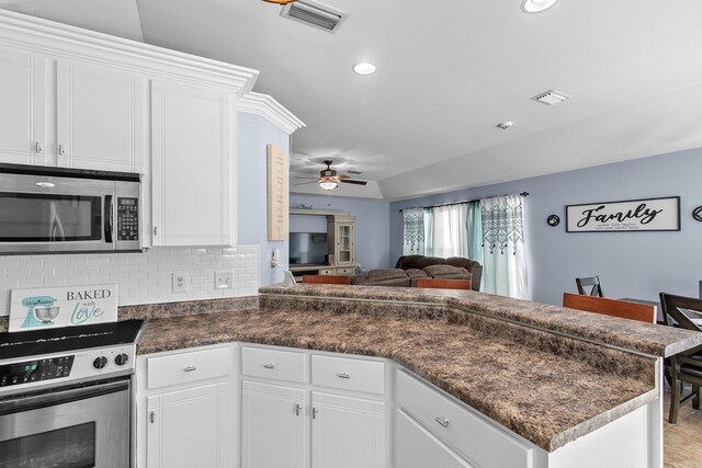 404 Powder Horn Dr, Midland City, AL 36350 - kitchen with dark countertops, a ceiling fan, open floor plan, a peninsula, and appliances with stainless steel finishes