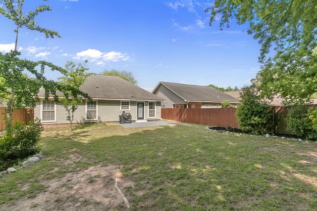 404 Powder Horn Dr, Midland City, AL 36350 - rear view of property with a lawn, a fenced backyard, and a patio