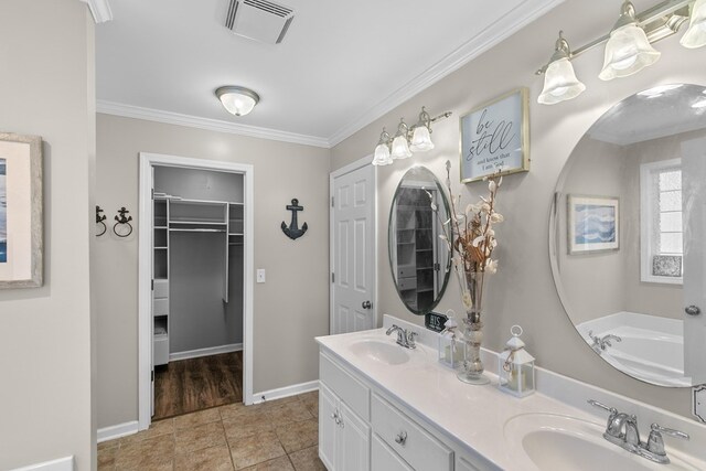 404 Powder Horn Dr, Midland City, AL 36350 - bathroom with a spacious closet, crown molding, a sink, and visible vents
