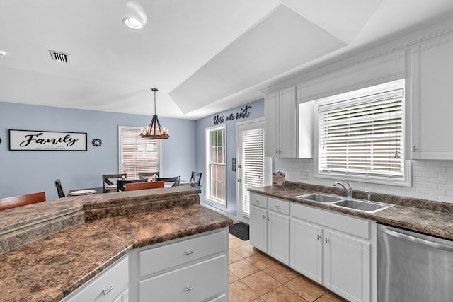 404 Powder Horn Dr, Midland City, AL 36350 - kitchen featuring stainless steel dishwasher, a sink, light tile patterned flooring, dark countertops, and decorative backsplash