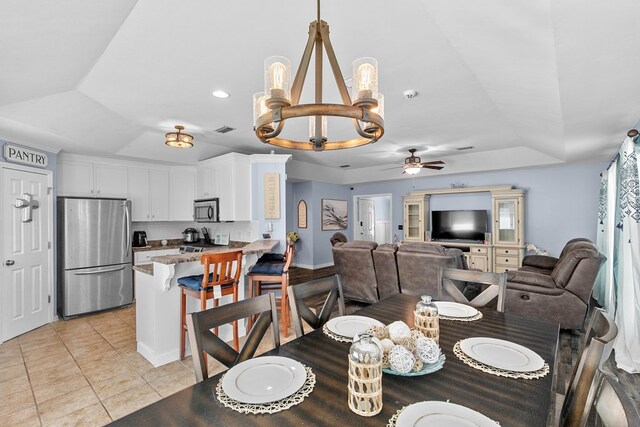 404 Powder Horn Dr, Midland City, AL 36350 - dining space featuring ceiling fan with notable chandelier, light tile patterned floors, a raised ceiling, visible vents, and recessed lighting
