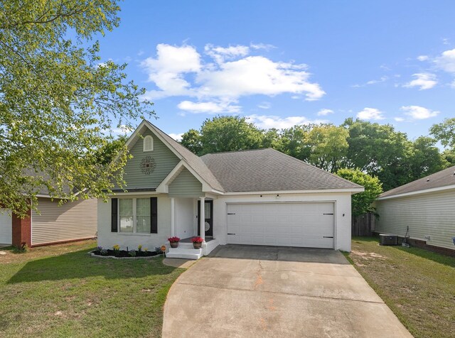 404 Powder Horn Dr, Midland City, AL 36350 - view of front facade featuring concrete driveway, central air condition unit, a shingled roof, an attached garage, and a front yard