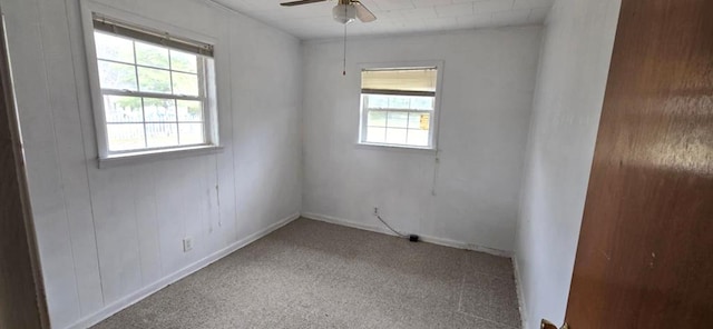 carpeted empty room featuring ceiling fan