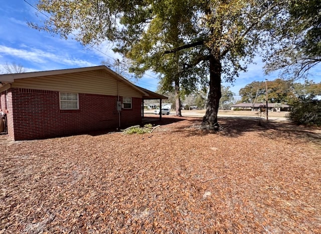 view of side of property featuring brick siding