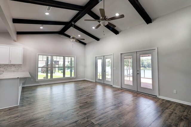 1272 Otho Rd, Abbeville, AL 36310 - unfurnished living room with ceiling fan, french doors, beam ceiling, dark wood-type flooring, and high vaulted ceiling