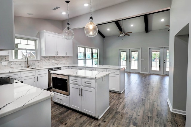 1272 Otho Rd, Abbeville, AL 36310 - kitchen featuring a peninsula, ceiling fan, tasteful backsplash, white cabinets, and open floor plan