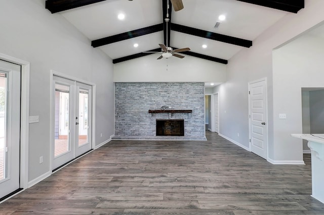 1272 Otho Rd, Abbeville, AL 36310 - unfurnished living room featuring a ceiling fan, a fireplace, beamed ceiling, wood finished floors, and high vaulted ceiling