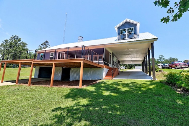1272 Otho Rd, Abbeville, AL 36310 - back of property with a lawn, a metal roof, a wooden deck, and a garage