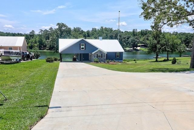 1272 Otho Rd, Abbeville, AL 36310 - view of front of house featuring concrete driveway, a water view, a front lawn, and a metal roof