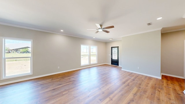 unfurnished room with visible vents, ceiling fan, baseboards, and a healthy amount of sunlight