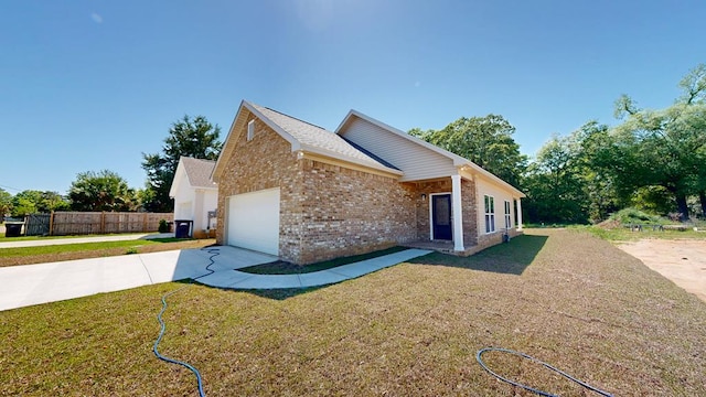 view of front facade featuring concrete driveway, a front lawn, brick siding, a garage, and fence