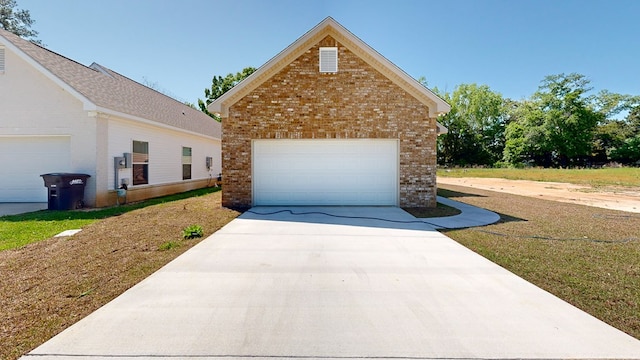 view of front of house with brick siding, an outdoor structure, and a garage