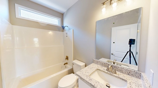 bathroom with toilet, vanity, and tub / shower combination
