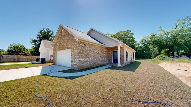 exterior space with brick siding, fence, a garage, and driveway