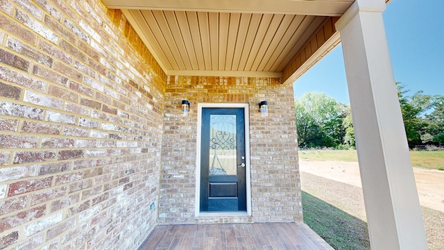 property entrance featuring brick siding