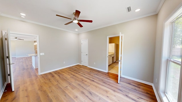unfurnished bedroom with light wood-type flooring, baseboards, ornamental molding, and visible vents