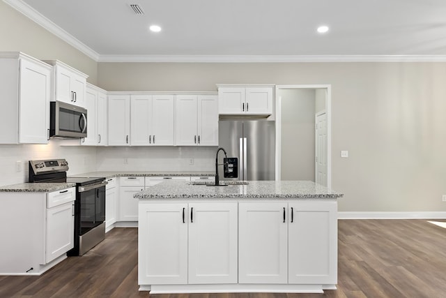 kitchen featuring appliances with stainless steel finishes, a sink, light stone counters, and white cabinets