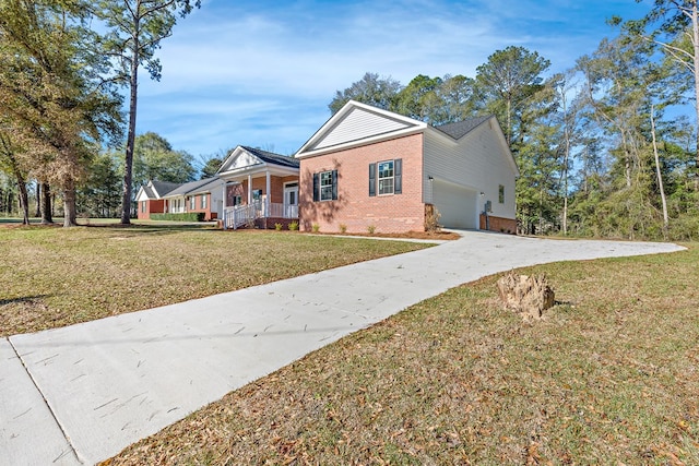 view of front of property featuring brick siding, covered porch, an attached garage, a front yard, and driveway