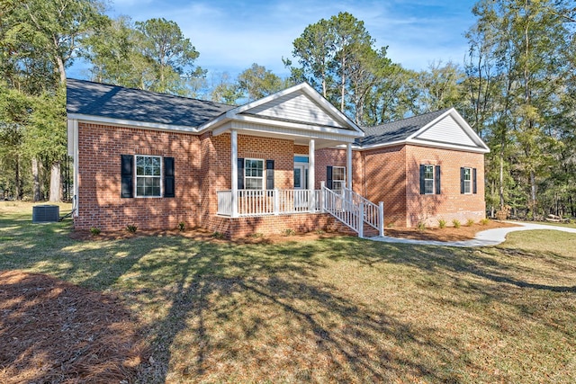 greek revival house with a porch, brick siding, and a front lawn