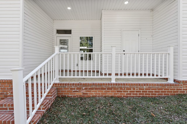 doorway to property featuring brick siding