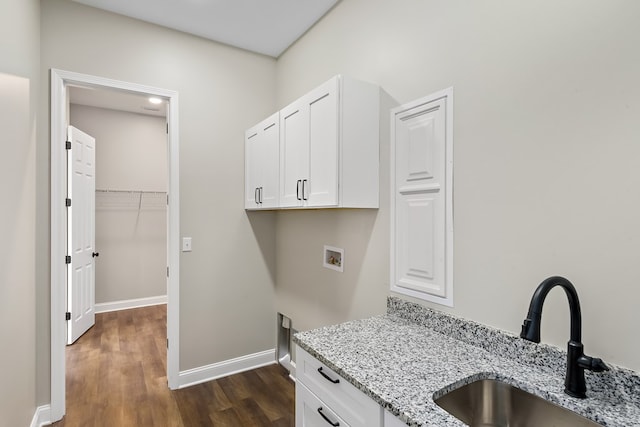 laundry area featuring hookup for a washing machine, dark wood-style flooring, a sink, baseboards, and cabinet space