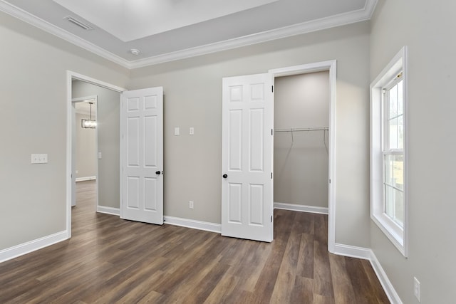 unfurnished bedroom featuring ornamental molding, dark wood-type flooring, and baseboards