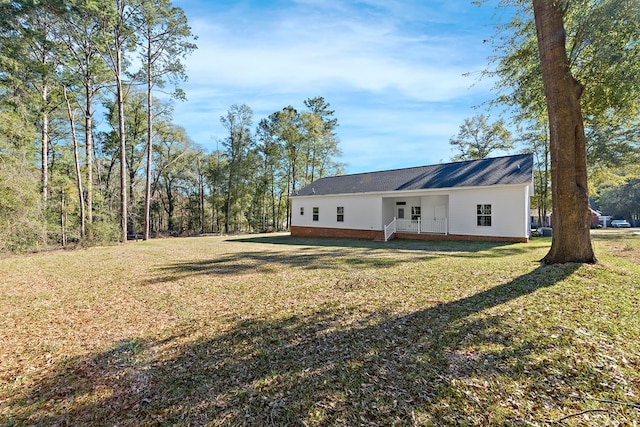 view of front of home with metal roof and a front lawn