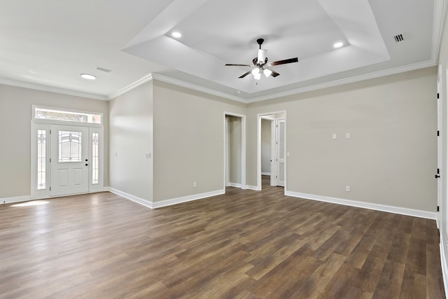 entrance foyer with crown molding, baseboards, a raised ceiling, and dark wood-style flooring