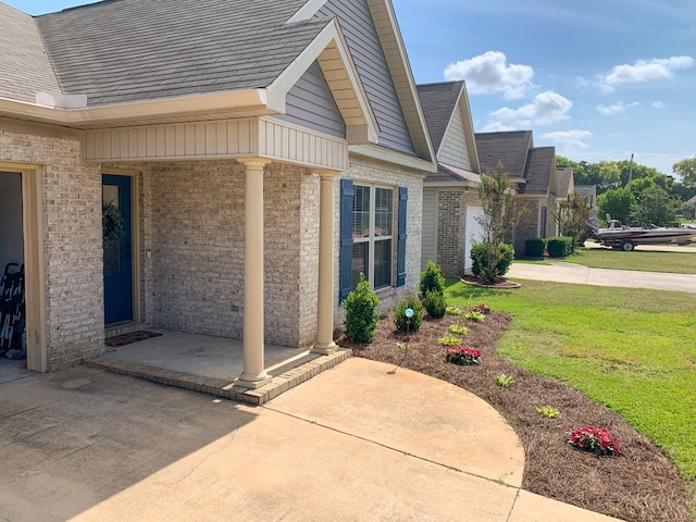 202 Moonlight Ln, Midland City, AL 36350 - property entrance featuring brick siding, a yard, driveway, and a shingled roof
