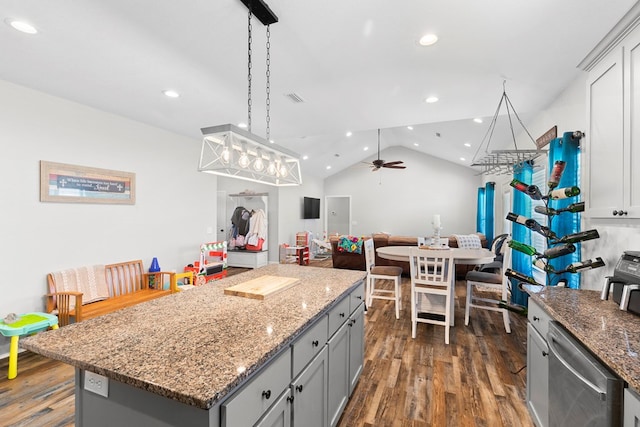 kitchen with dark wood-style floors, a kitchen island, vaulted ceiling, and gray cabinetry