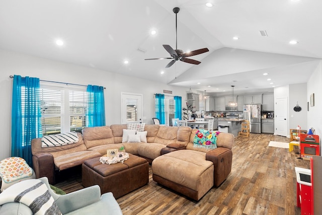 living area with lofted ceiling, ceiling fan, light wood-style flooring, and recessed lighting