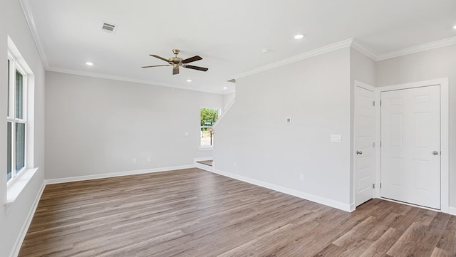 empty room featuring ceiling fan, light hardwood / wood-style floors, and crown molding