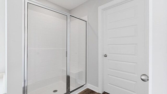 bathroom with hardwood / wood-style floors and walk in shower