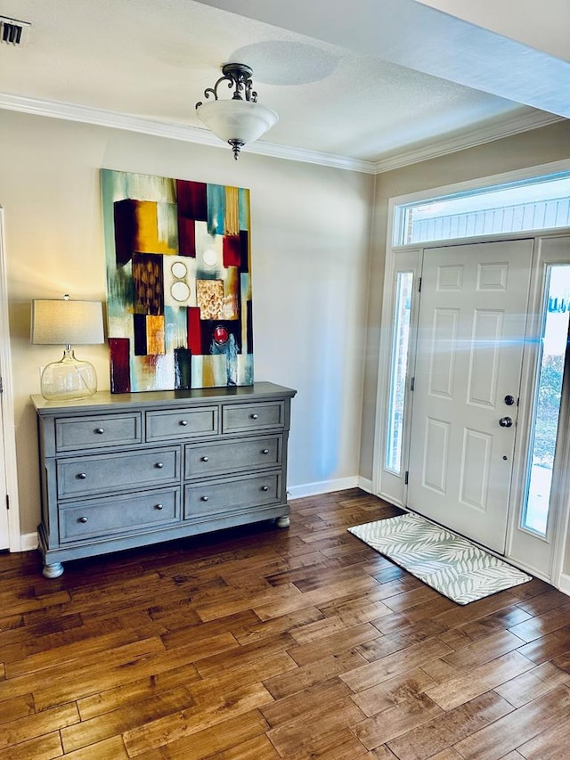 foyer entrance featuring dark hardwood / wood-style flooring, plenty of natural light, and crown molding