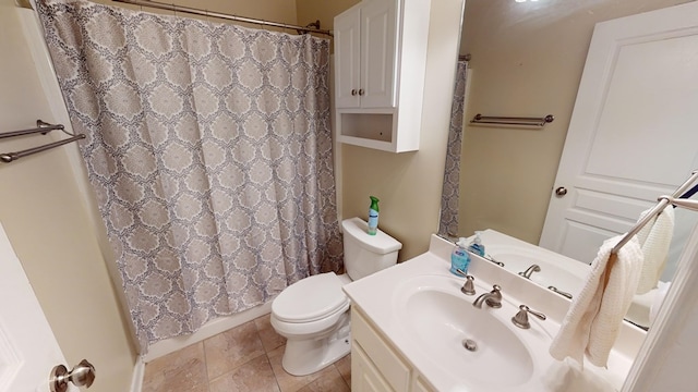 bathroom with toilet, curtained shower, tile patterned floors, and vanity