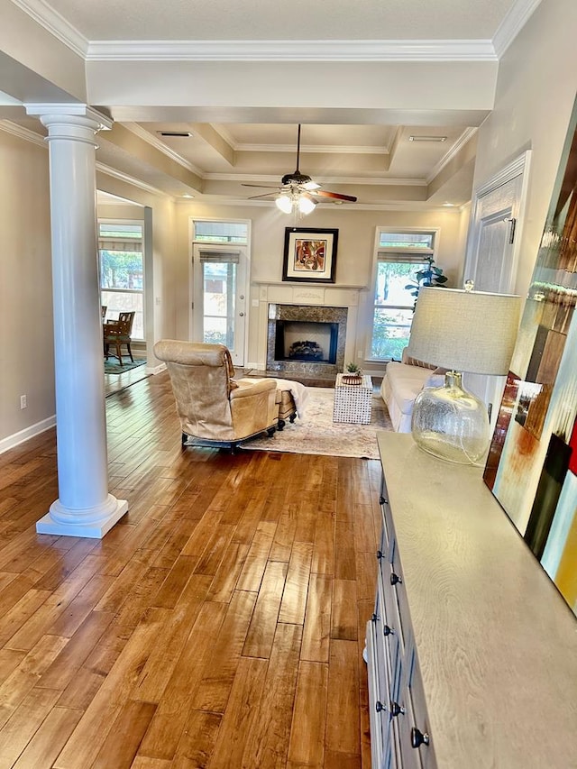 living room with ceiling fan, crown molding, and wood-type flooring